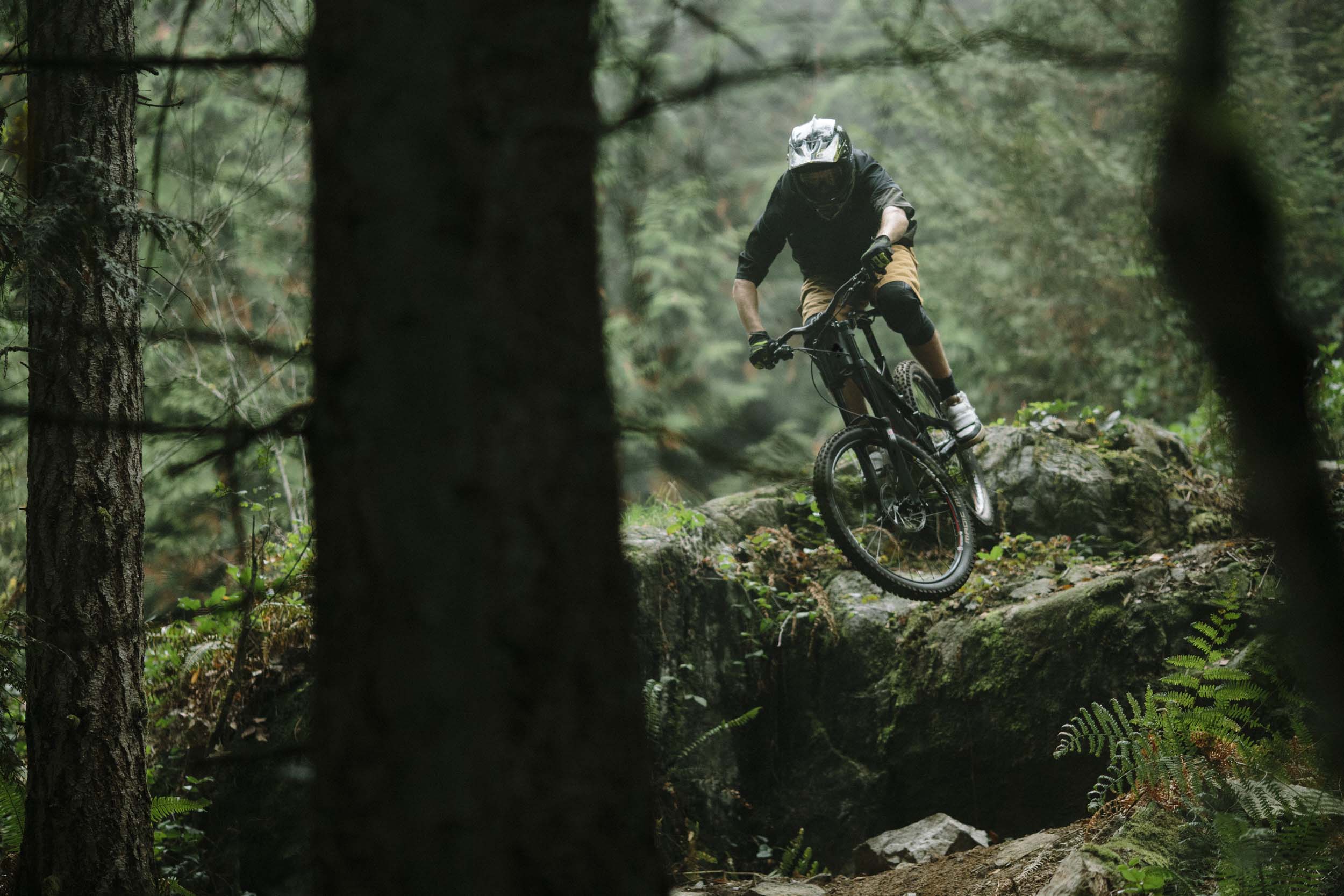 David Watson mid-air on his mountain bike